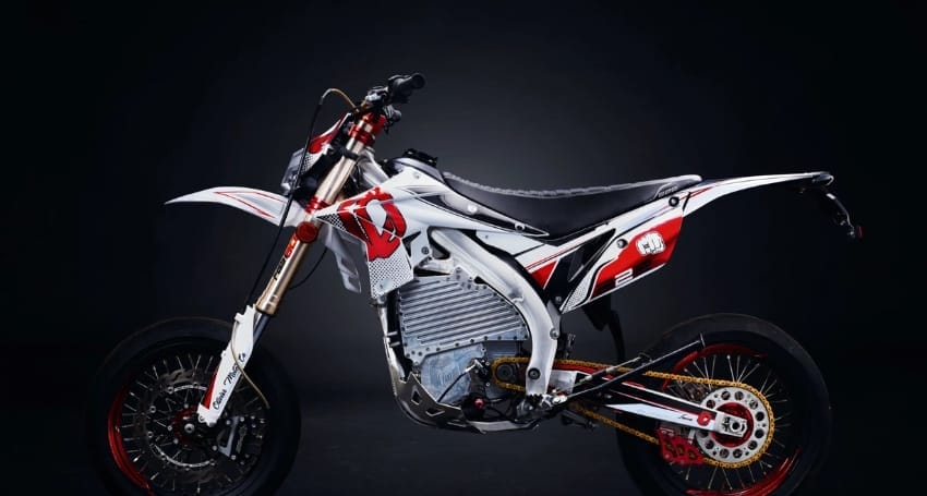 Revolutionary electric motocross bike against a dark background.