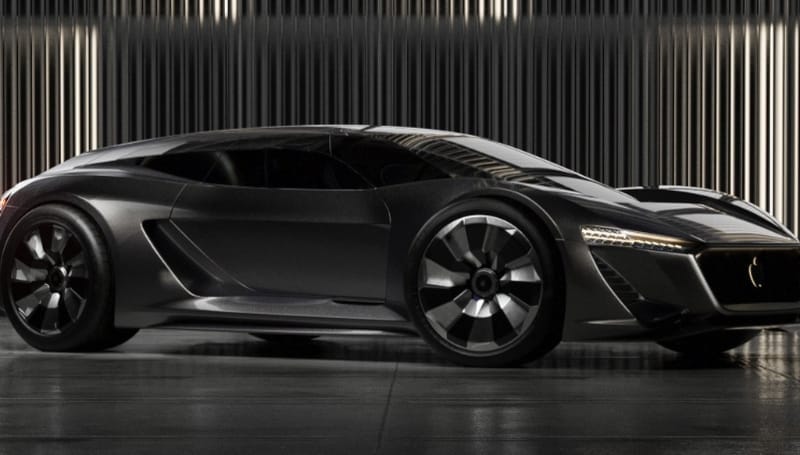 A sleek, dark-colored, futuristic sports car is parked indoors in front of vertical metallic panels.