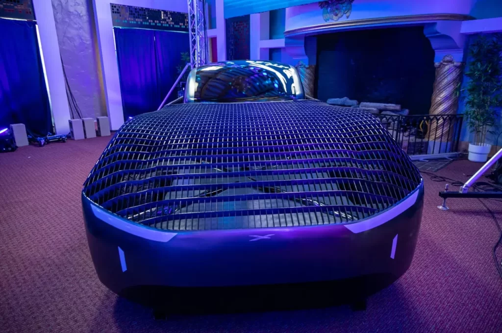 A futuristic car on display in a room.