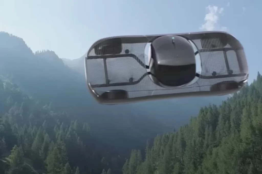 A drone flying in the air over a forest.