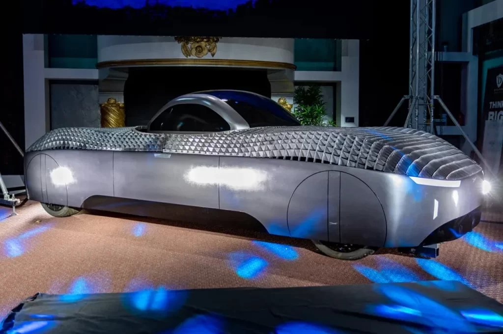 A futuristic car is on display in a room.
