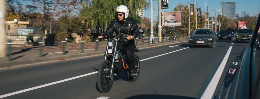A man riding a bicycle down a city street.