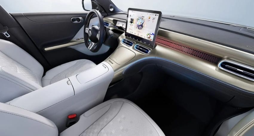Interior view of a modern car featuring a white and gray color scheme, with a large central touchscreen and streamlined dashboard design.