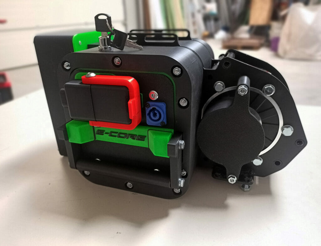 A small camera on a table with a green button.