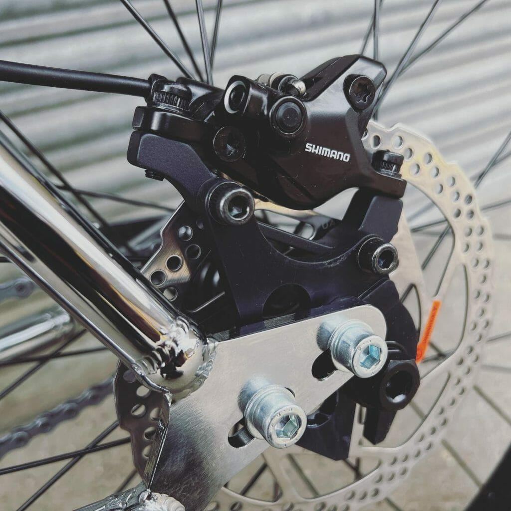 A close up of a bicycle with a brake on it.
