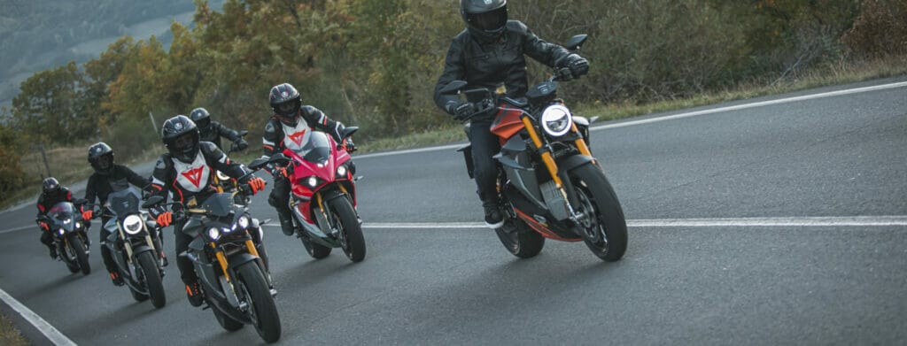 a group of people riding on the back of a motorcycle