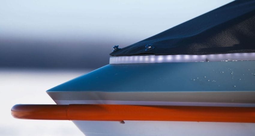 An orange and white boat with a light on the side, designed by Pininfarina.