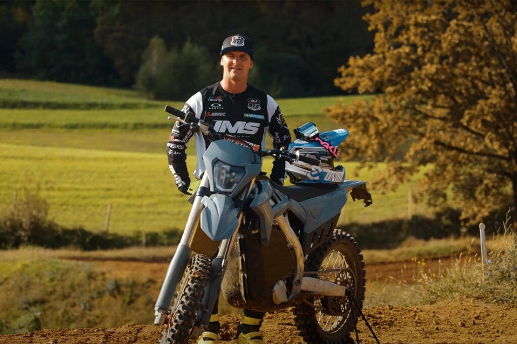 A man on a dirt bike in a field.
