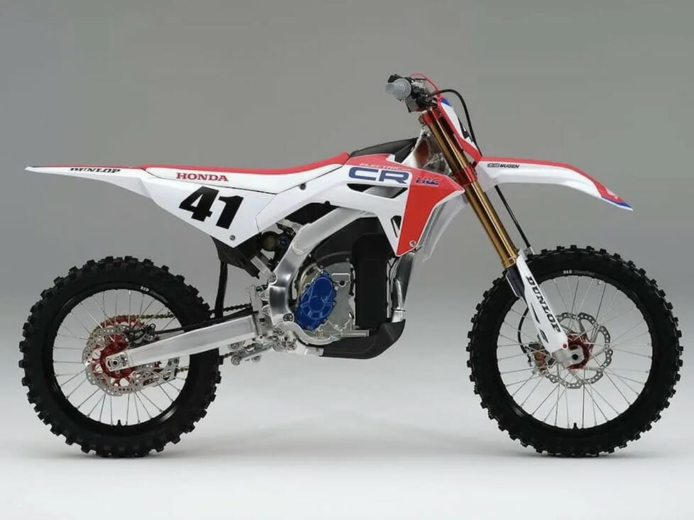 A red and white dirt bike on a white background at Honda's CR ELECTRIC PROTO Debut in Japan Motocross 2023.