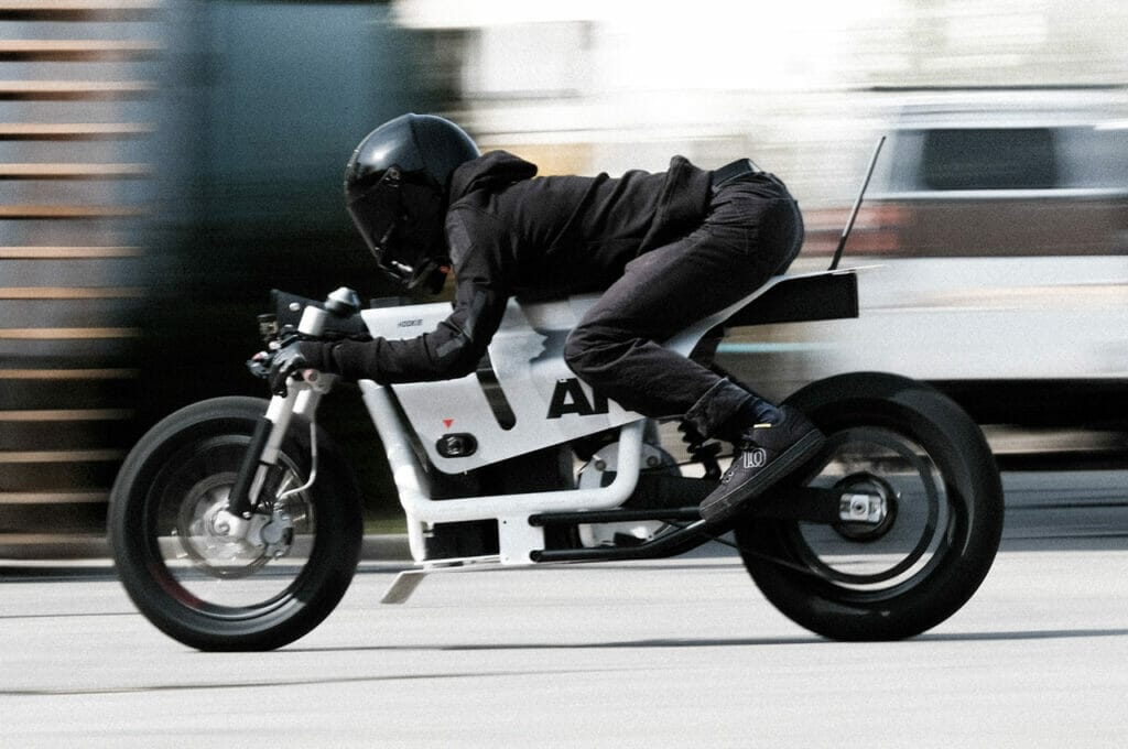 a man riding a motorcycle down a street