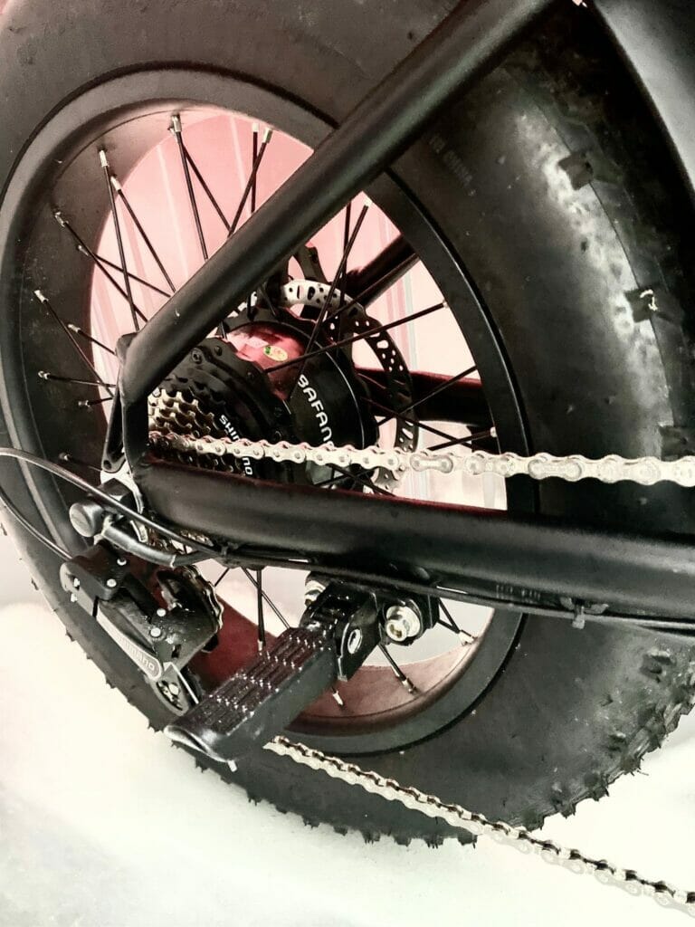 A close up of a motorcycle with chains on it.