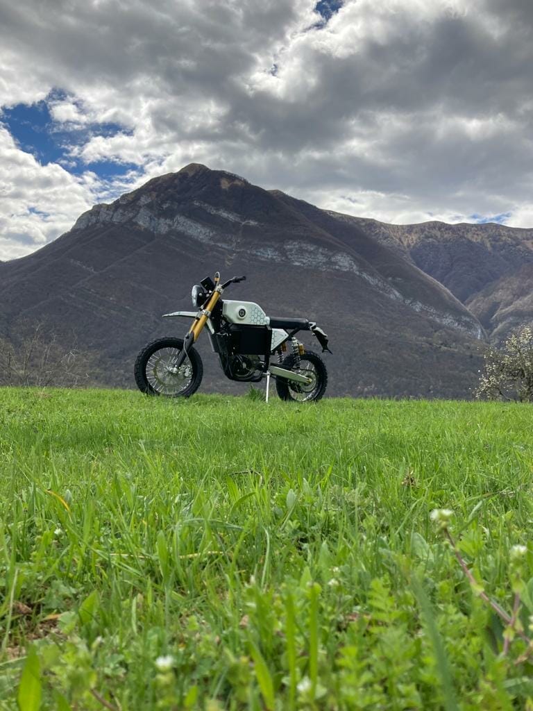 a motorcycle is parked on the side of a mountain