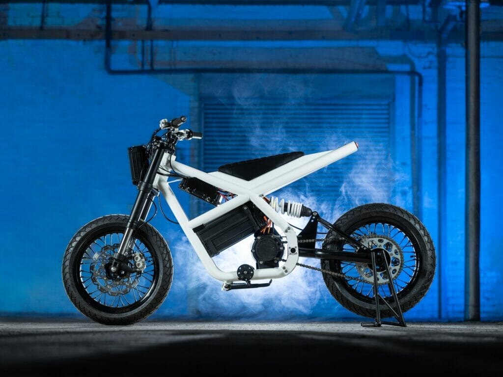 Untitled's Death to Petrol Electric Supermoto Vision motorcycle in a dark room.