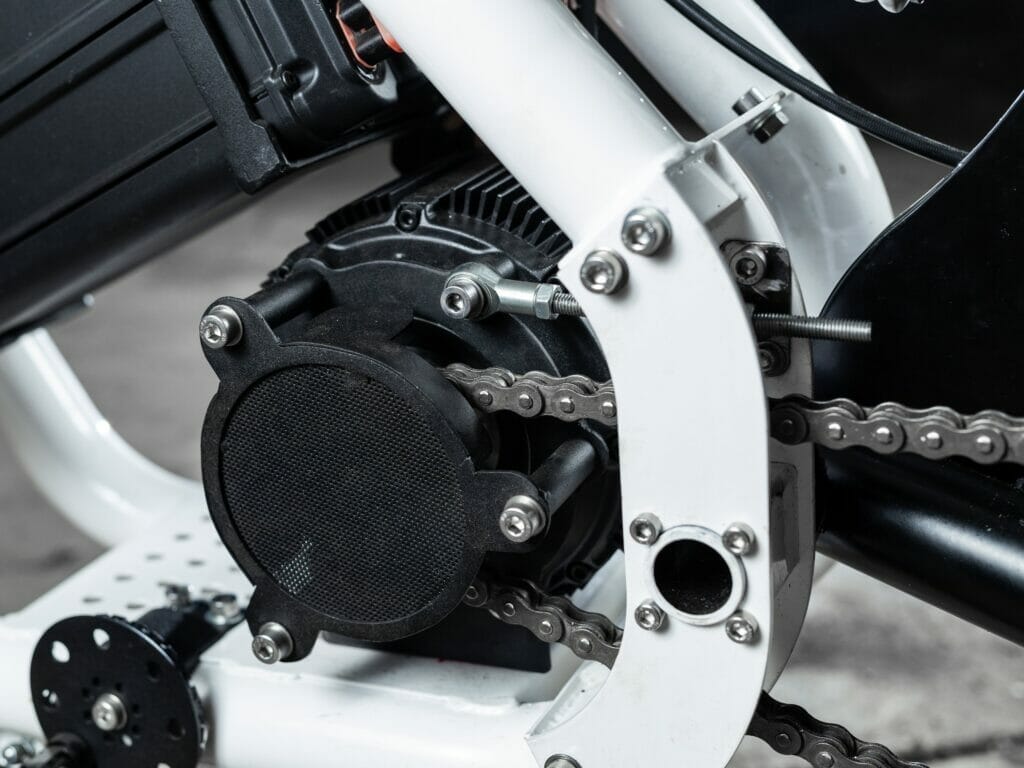A close up of an electric bicycle with a chain attached to it.