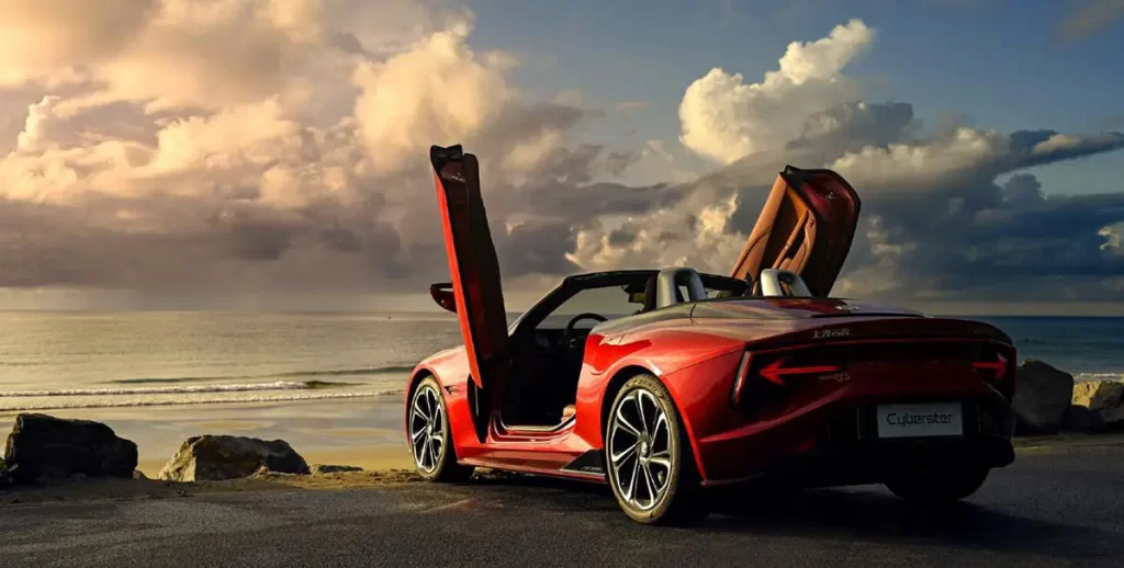 A red sports car on the beach.