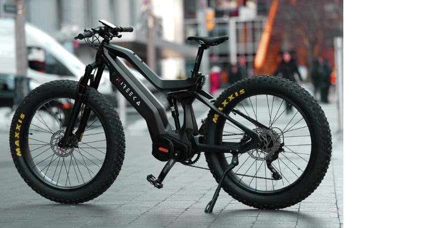 An electric bike, part of the urban commuting revolution, is parked on a city street.