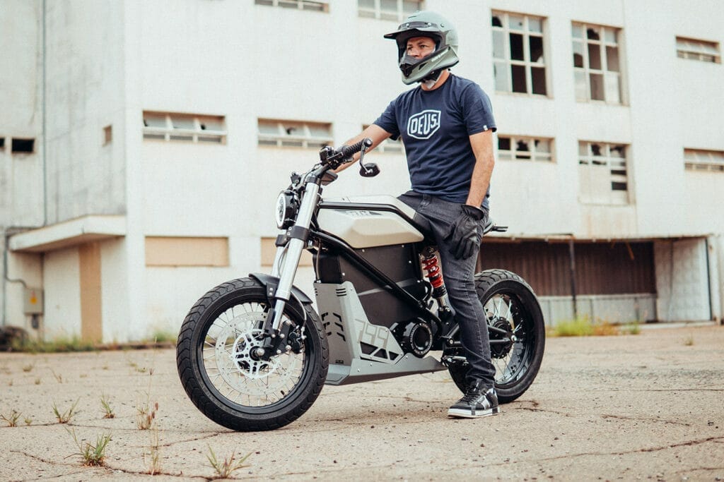 a man riding a motorcycle down a dirt road