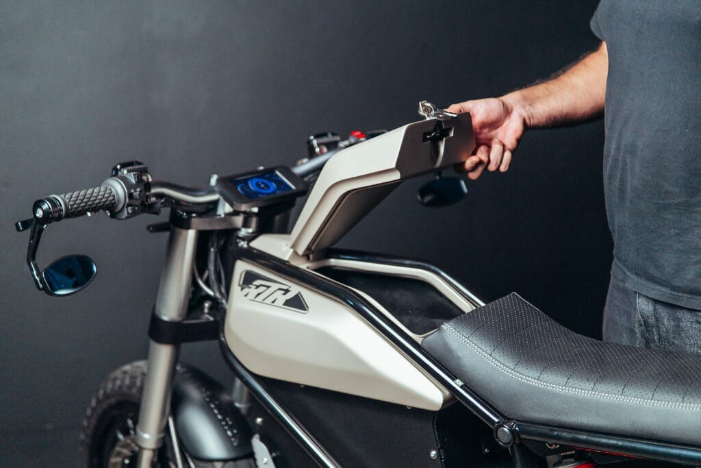 a man standing next to a motorcycle