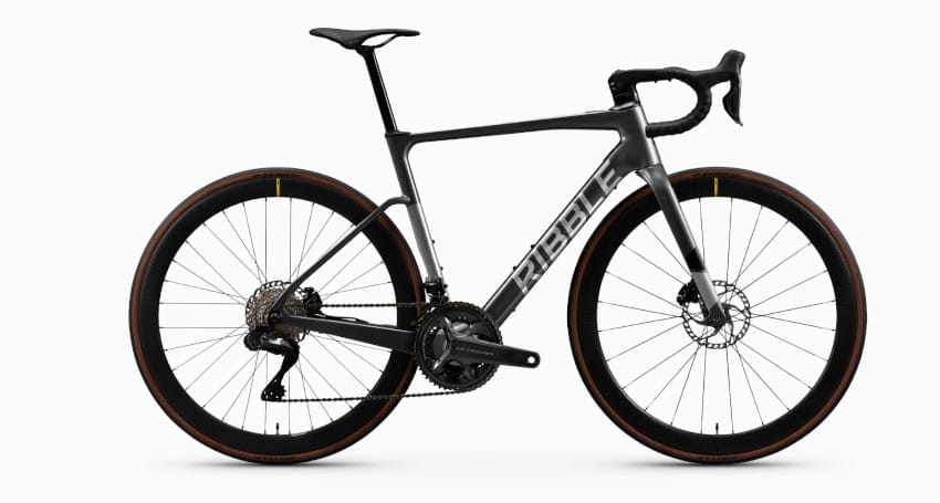 A sleek, black Ribble Endurance road bicycle with drop handlebars and thick tires, featuring the Ribble logo on the frame, now available as the lightest electric bike in its class.