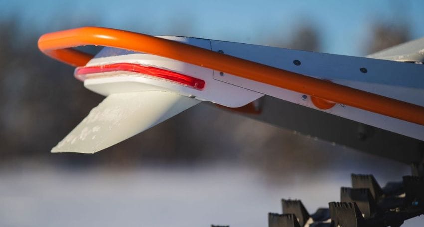 The rear end of an electric snowmobile designed by Pininfarina Launch and Vidde Mobility is shown in the snow.