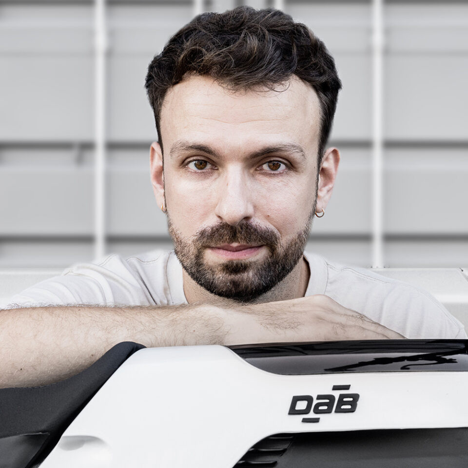 Simon Dabadie, the owner of  DAB Motors rests his head on their electric motorbike