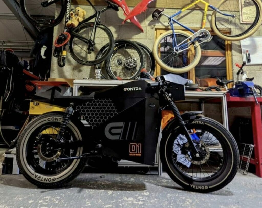 A black motorcycle parked in a garage.