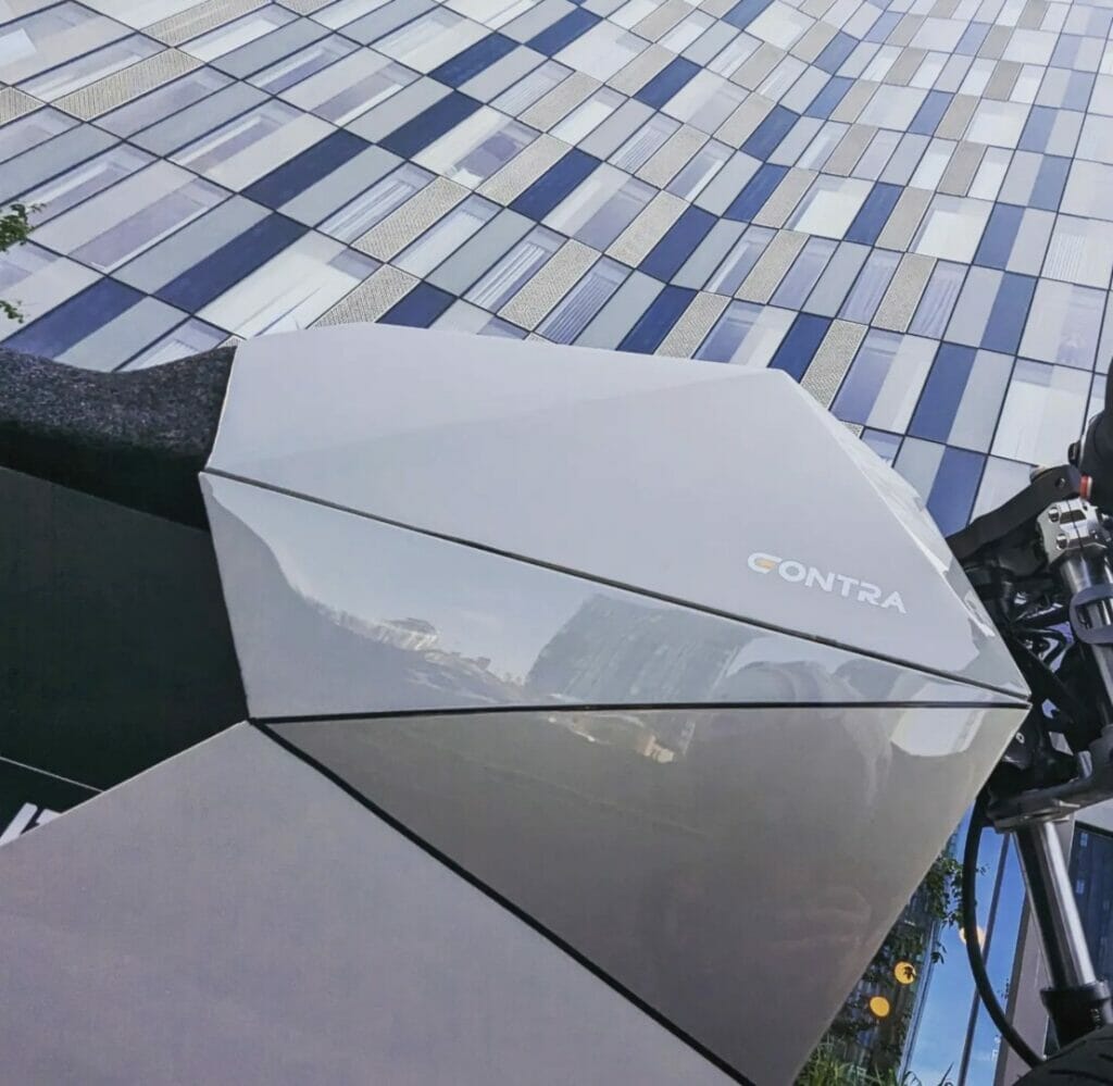 A camera is sitting on a tripod in front of a building.