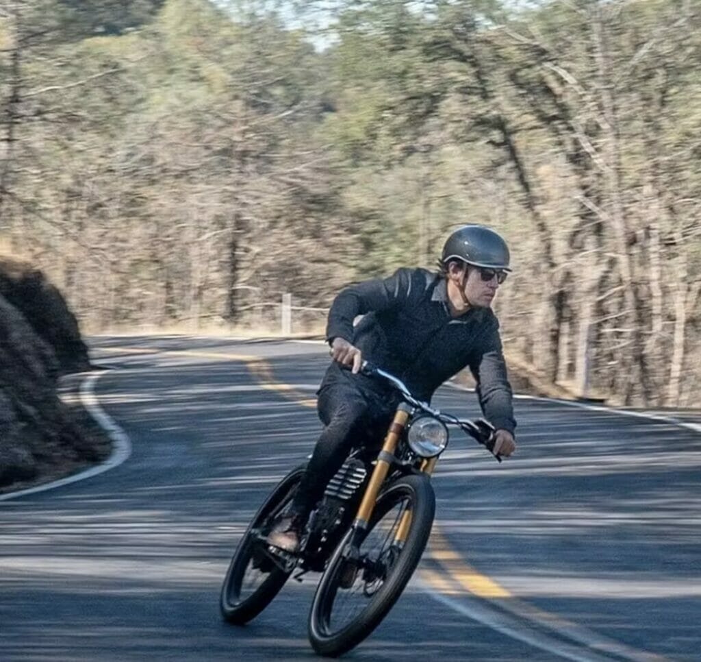 A man riding a high-quality electric bike down a mountain road.