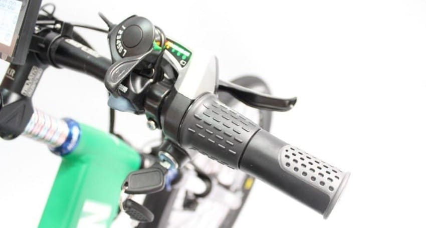 A close up of the handlebars of an e-bike with throttle.