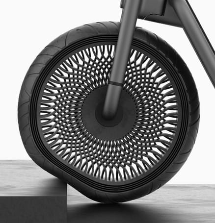 A black bicycle with a shining wheel on top of it, showcasing a 2019 concept design.