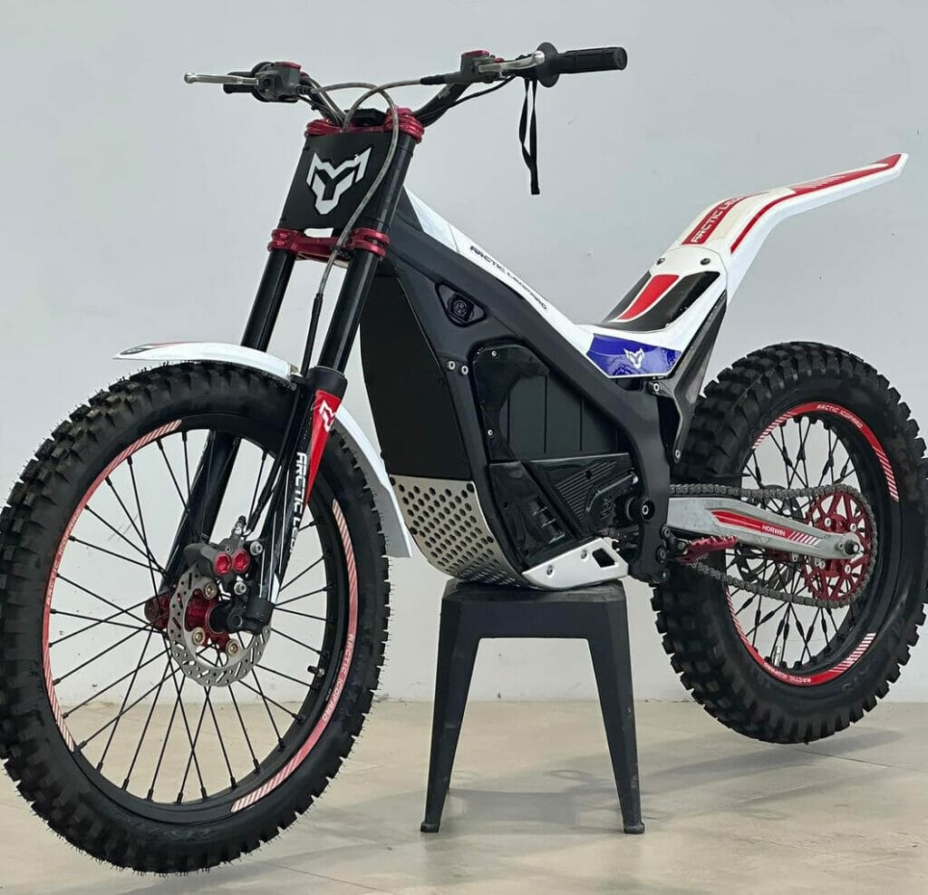 An electric dirt bike on a stand.