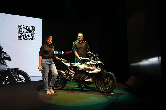 A man and woman standing next to Orxa Energies' Mantis, the lightest electric motorcycle.