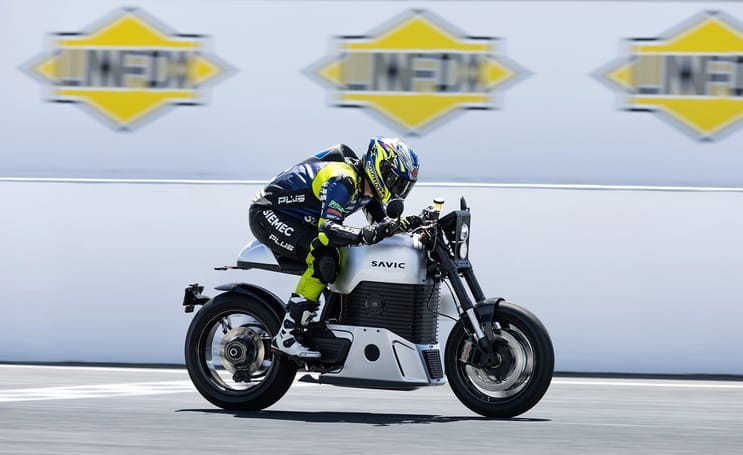 An exhilarating high-speed test of a person riding a C-Series Triumph motorcycle on a track.