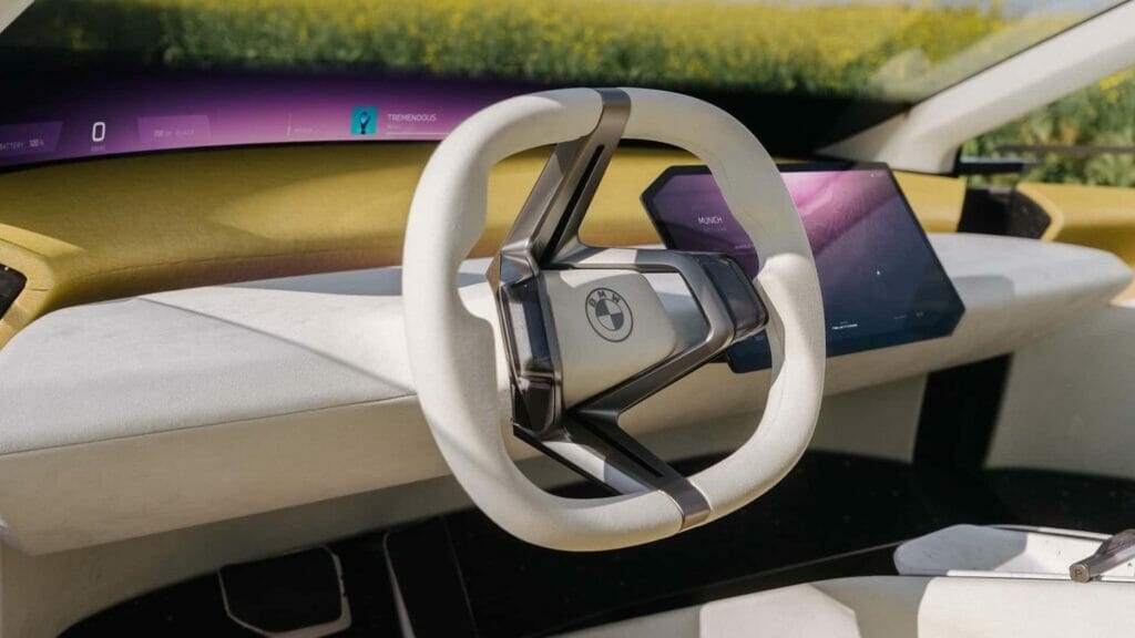A futuristic car with a minimalist design boasting a steering wheel and a giant head-up display.
