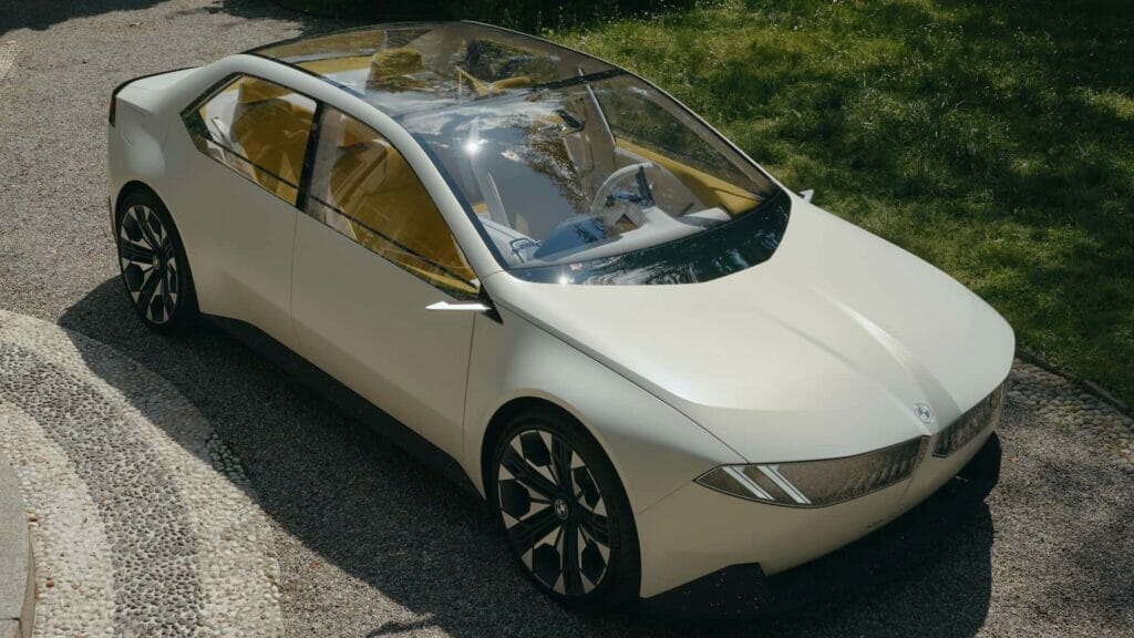BMW's minimalist EV concept car, the Vision Neue Klasse, is parked on the side of the road showcasing its giant head-up display.