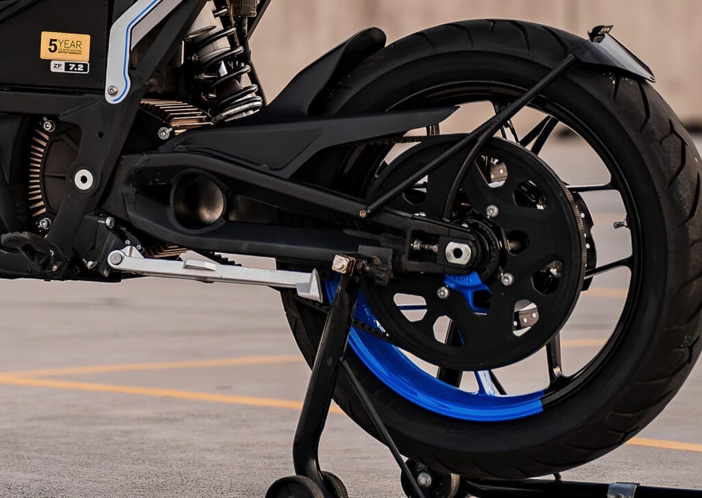 A black and blue motorcycle is parked in a parking lot.