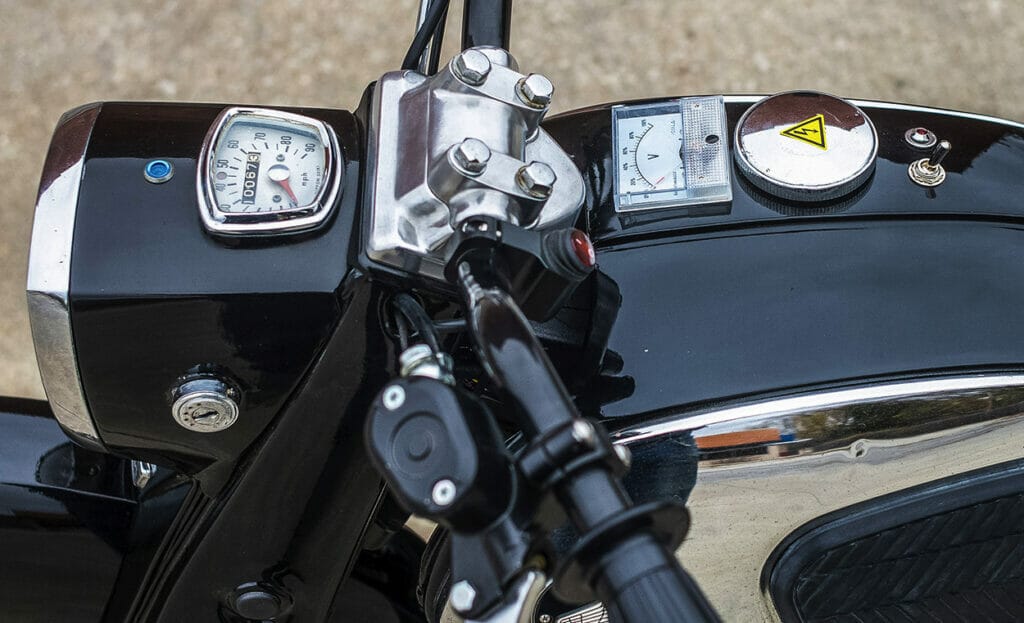 A close up of the handlebars of a motorcycle transformed into a seamless and silent beauty.