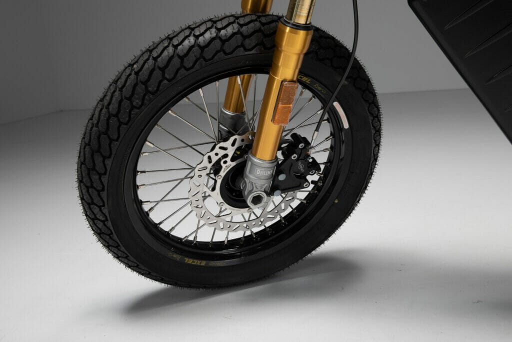 A close up of the front wheel of a Trevor motorcycle.