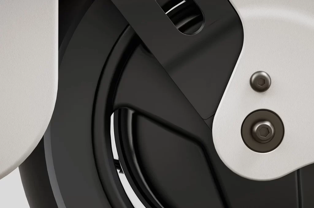 A close up view of the wheel of a motorcycle at Kawasaki's Z-e1 and Ninja-e1 unveiling.