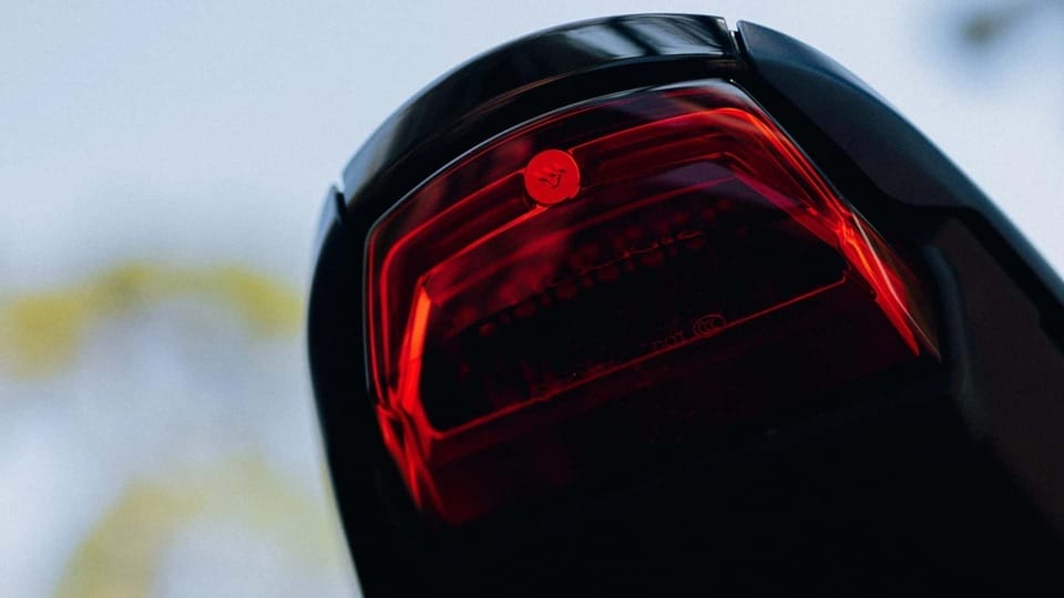A close up of a red tail light on a motorcycle.