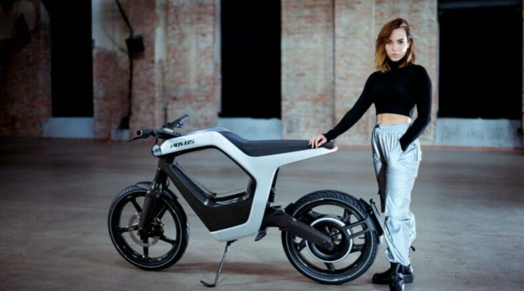 A woman standing next to a NOVUS <a href=