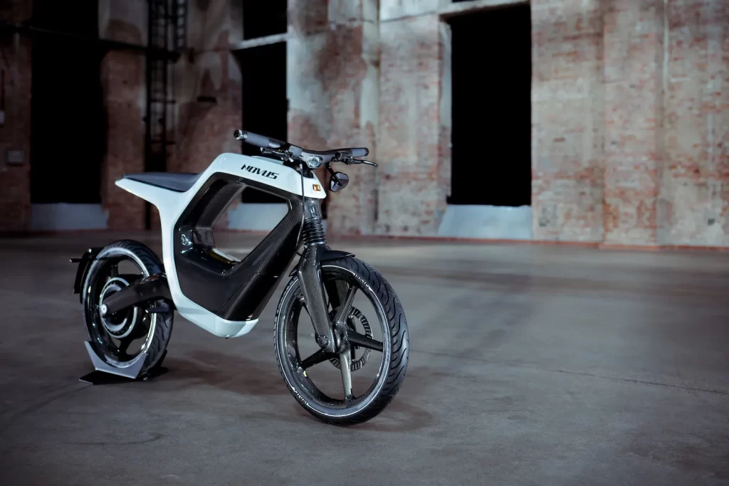 A white and black electric bike parked in a warehouse.