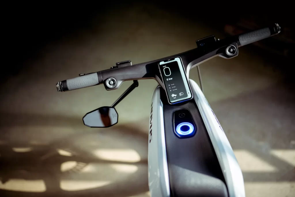 The handlebar of an electric bike with a blue light on it.