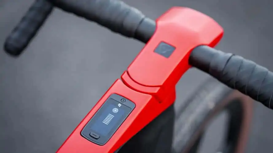 A close up of the handlebar of a red bicycle.