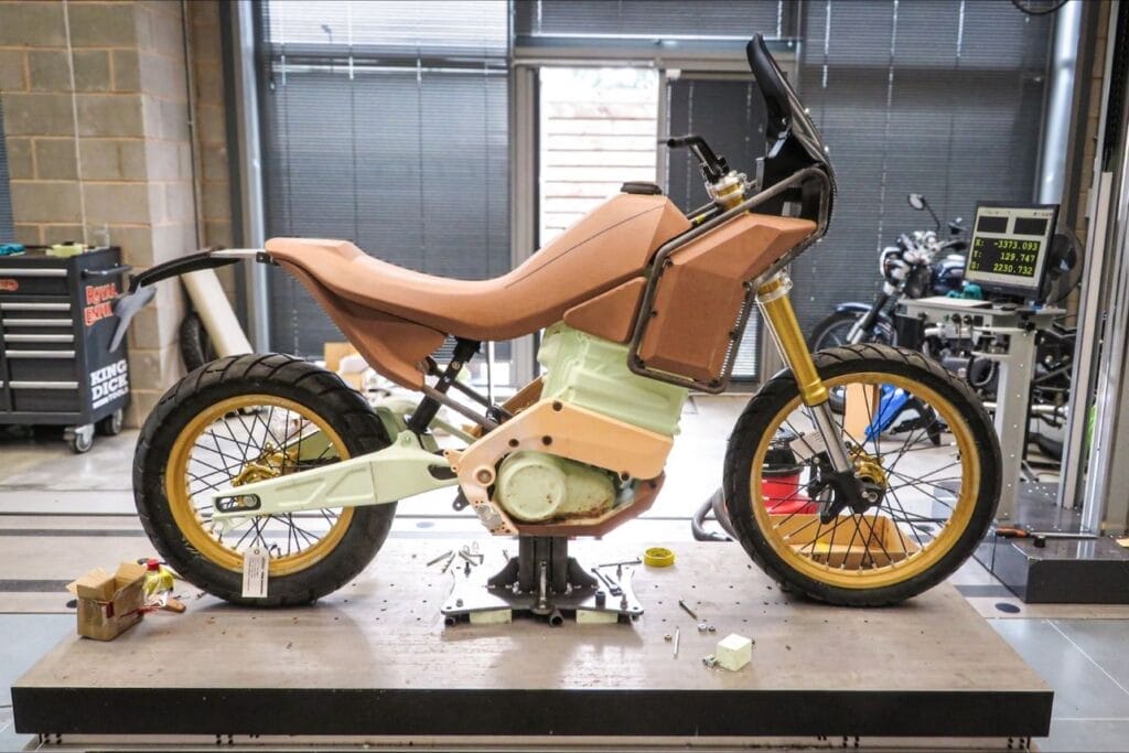 A motorcycle is sitting on a table in a garage.