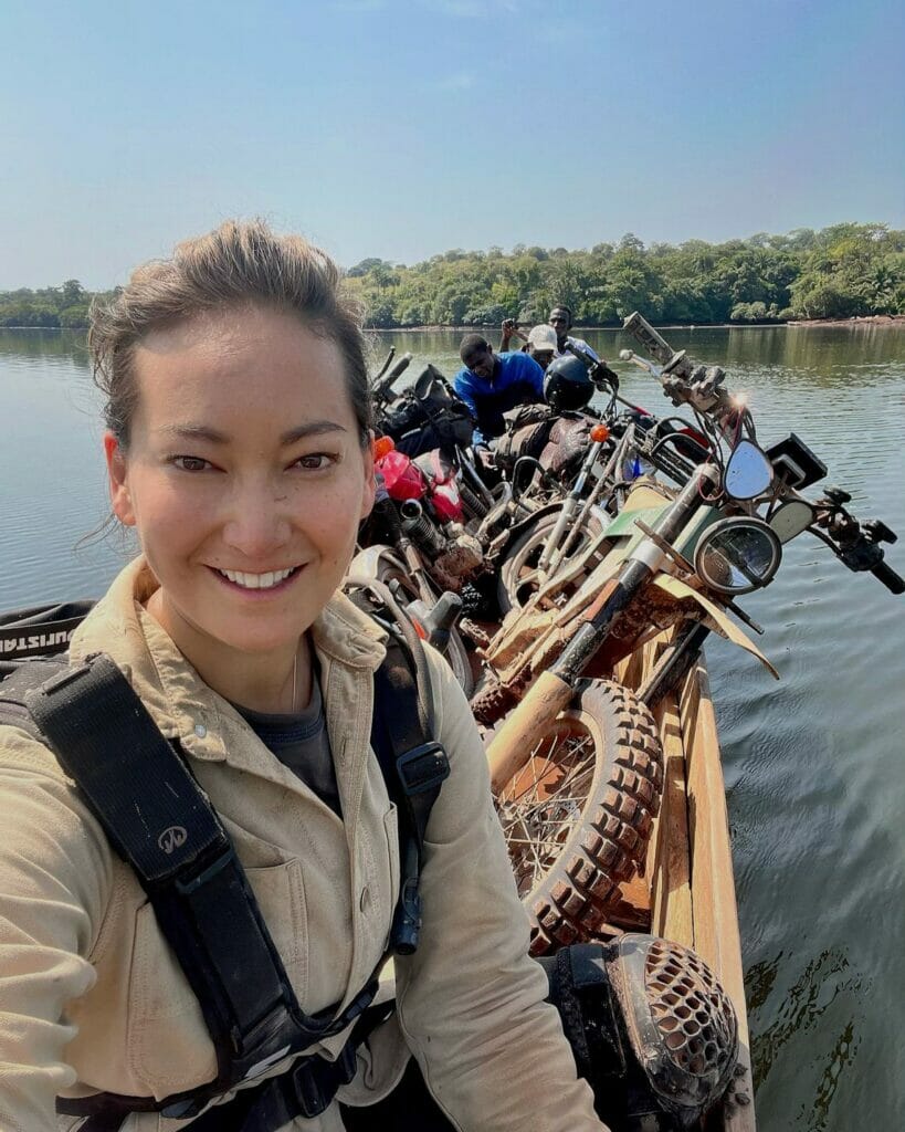 A woman on a boat with a lot of motorcycles.