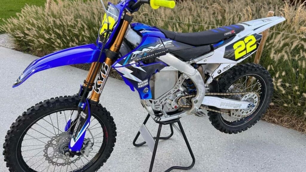 A blue and white dirt bike on display at Auto Draft.