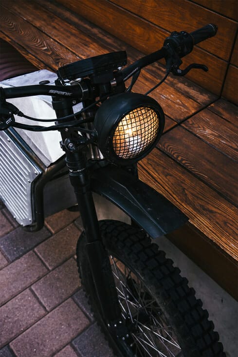 A motorcycle parked wooden bench.
