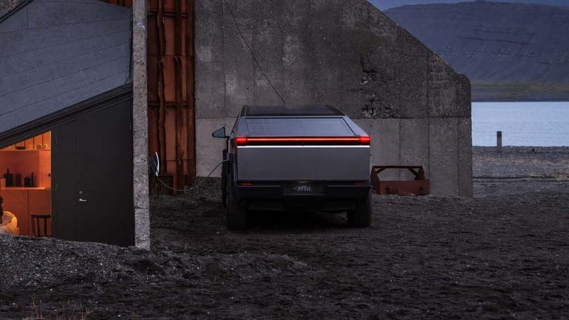 A Tesla Cybertruck is parked in front of a building in Iceland.