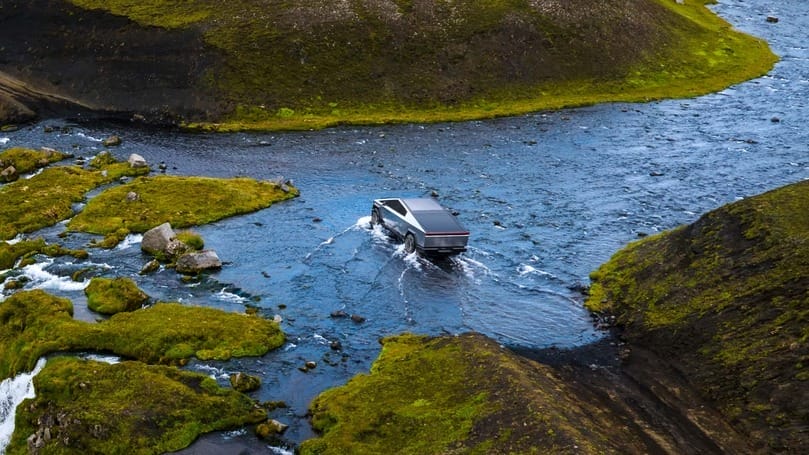 A suv driving through a river in iceland, facing Tesla's Cybertruck dilemma in Musk's Vision.